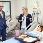 KEITH THORPE/PENINSULA DAILY NEWS
Gov. Jay Inslee  looks at a patient simulator as Peninsula College nursing instructional technician Terresa Taylor describes its workings during a tour of the college's Nursing Simulation Lab on Friday in Port Angeles.