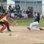 Elks catcher Kyler Williams prepares to make a tag on Lions baserunner Gavin Doyle trying to steal home in the Cal Ripken Majors championship game this weekend. Doyle was out at the plate and Elks went on to win 16-6. In addition to making this play, Williams batted 5-for-5 in the game. (Dave Logan/for Peninsula Daily News)