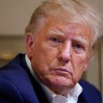 Former President Donald Trump listens as he speaks with reporters while in flight on his plane after a campaign rally at Waco Regional Airport, in Waco, Texas, March 25, while en route to West Palm Beach, Fla. (AP Photo/Evan Vucci, File)