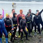 Participants in the Maritime Festivals Orca Bait Swim pump themselves up on Ediz Hook before heading out across the harbor. The inaugural event drew 12 swimmers and three orcas, whose paths did not happen to meet over the 1 1/2-mile course. (Paula Hunt/Peninsula Daily News)