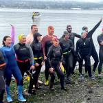 Participants in the Maritime Festivals Orca Bait Swim pump themselves up on Ediz Hook before heading out across the harbor. The inaugural event drew 12 swimmers and three orcas, whose paths did not happen to meet over the 1 1/2-mile course. (Paula Hunt/Peninsula Daily News)