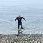 Doug Winter, 54, of Sequim arrives at the finish of the Maritime Festivals Orca Bait Swim 10 minutes ahead of his nearest competitor. Winter completed the 1 1/2-mile course from Ediz Hook to Pebble Beach in 35 minutes. (Paula Hunt/Peninsula Daily News)