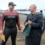 Orca Bait Swim winner Doug Winter of Sequim, right, jokes with fellow swimmer and event organizer Rob DeCou at an awards ceremony at Pebble Beach Park in Port Angeles after Saturdays race. (Keith Thorpe/Peninsula Daily News)