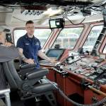 Dick Grinstad of Port Angeles, left, listens as U.S. Coast Guard Chief Warrant Officer John Elsbree describes operations of the Cutter Wahoo while moored at Port Angeles City Pier during Saturdays Maritime Festival. (Keith Thorpe/Peninsula Daily News)