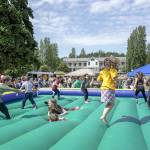 Kids get a kick out of the bouncy jumper at the free Field Day event at Fort Worden State Park on Saturday. The event included a range of games, prizes and live entertainment presented by The Production Alliance and Fort Worden Hospitality. (Steve Mullensky/for Peninsula Daily News)