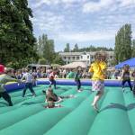 Kids get a kick out of the bouncy jumper at the free Field Day event at Fort Worden State Park on Saturday. The event included a range of games, prizes and live entertainment presented by The Production Alliance and Fort Worden Hospitality. (Steve Mullensky/for Peninsula Daily News)