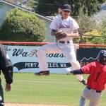 Port Angeles Lefties second baseman Robert Nunez jumps to catch a throw but isn't able to punch out Kelowna baserunner Eddie Fines on Sunday at Civic Field. (Dave Logan/for Peninsula Daily News)
