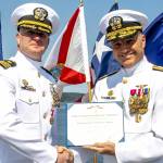 Navy Region Northwest Rear Admiral Mark Sucato, far right, shakes the hand of Cmdr. Todd Galvin as he takes command of Naval Magazine Indian Island.