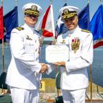 Navy Region Northwest Rear Admiral Mark Sucato, far right, shakes the hand of Cmdr. Todd Galvin as he takes command of Naval Magazine Indian Island.