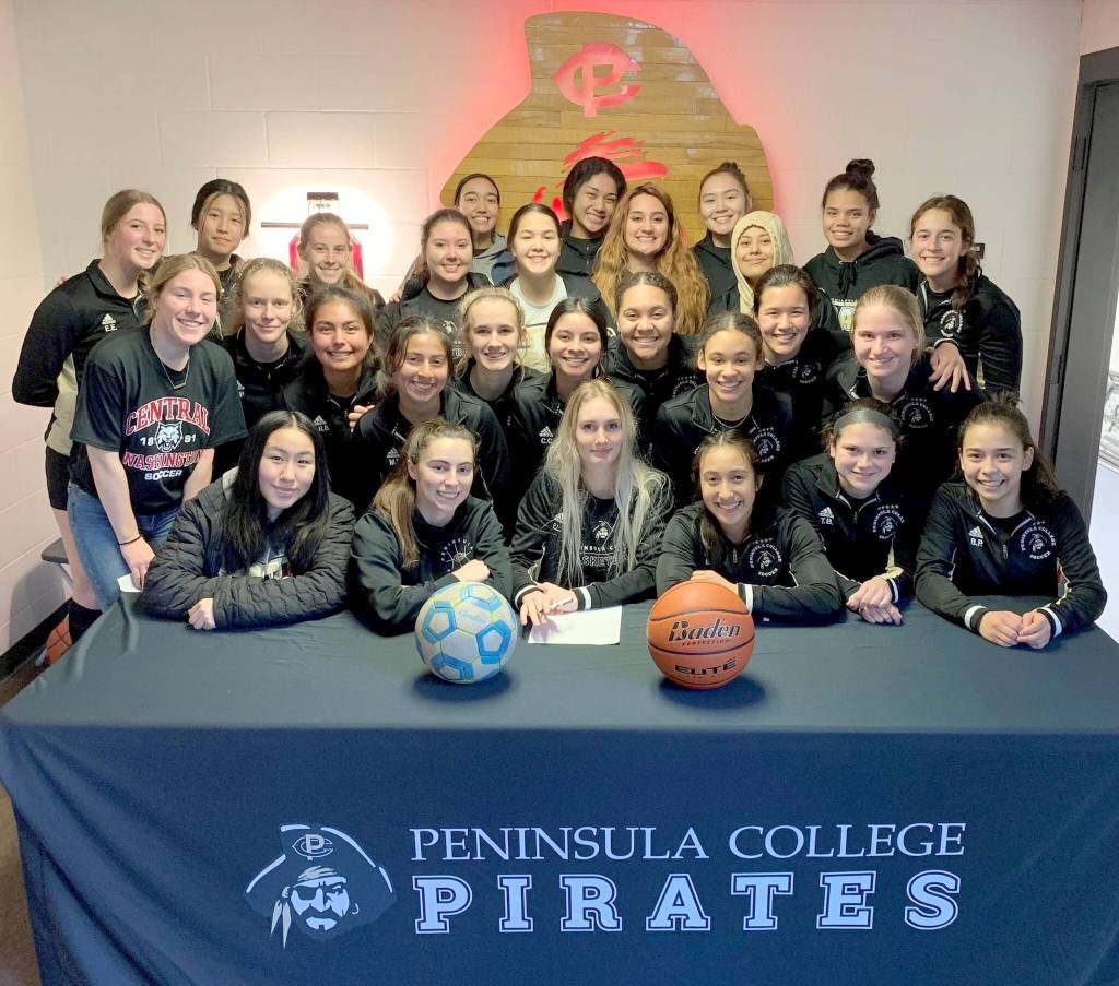 Millie Long, center, signs to play soccer and basketball at Cal Poly, Humboldt surrounded by her Peninsula College teammates. (Peninsula College)