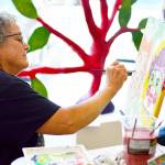 Virginia Ashby spent the afternoon of June 23 painting at Grover Gallery in Port Townsend, where her art is part of the "Psychedelic Summer" exhibition. photo courtesy of Northwind Art