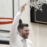 Keith Thorpe/Peninsula Daily News
Donald Rollman, head coach of the Peninsula Pirates mens team, waves a cut net in glory at the conclusion of Wednesday night's game against Everett with his team taking the NWAC North Region championship.