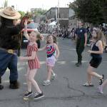 Smoky Bear, portrayed by state Department of Natural Resources employee Matt McBroom, is greeted by young parade-goers as fellow DNR employee Claire Lafrombois looks on during Tuesdays parade. (Keith Thorpe/Peninsula Daily News)
