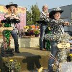 Clallam County Fair royalty, from left, Princess Olivia Ostlund, Junior Princess Kendall Adolphe and Queen Allison Pettit ride their festival float in the Port Angeles Independence Day parade. (Keith Thorpe/Peninsula Daily News)