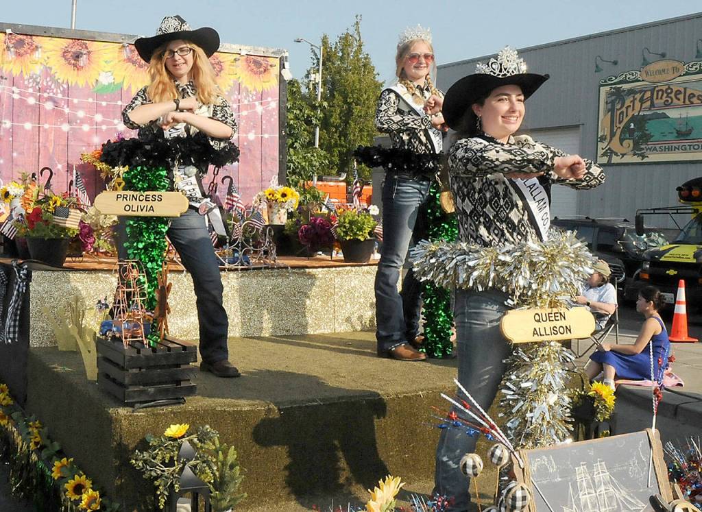 Clallam County Fair royalty, from left, Princess Olivia Ostlund, Junior Princess Kendall Adolphe and Queen Allison Pettit ride their festival float in the Port Angeles Independence Day parade. (Keith Thorpe/Peninsula Daily News)