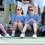 Port Angeles parade-goers, from left, Cate Chance, 13, Addy Fox, 13, Miriam Cobb, 13, and Angela Valles, 11, watch the festivities from a curb at First and Laurel streets on Independence Day in Port Angeles. (Keith Thorpe/Peninsula Daily News)