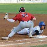 Port Angeles Roberto Nunez III slides safely back to first base as Wenatchees Easton Amundson is a tad late with the tag on the throw from the pitcher. (Dave Logan/for Peninsula Daily News)