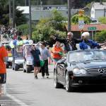Wes Fitzpatrick and Lorna Konopaski, grand pioneers for the Clallam Bay-Sekiu Fun Days parade, wave to the crowd on Saturday. The three-day celebration ended Sunday with a beach cleanup, fun run, tournaments and other activities. (Lonnie Archibald/for Peninsula Daily News)