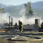 Firefighters with Clallam County Fire District 3 extinguish a fire after a home exploded on the 100 block of June Place on Tuesday evening. (Michael Dashiell/Olympic Peninsula News Group)