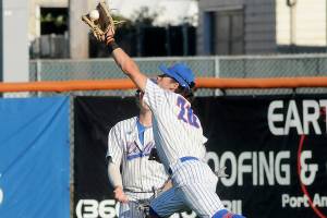 KEITH THORPE/PENINSULA DAILY NEWS
Lefties centerfielder Mauricio Guardado, makes a running catch on a deep fly ball as centerfielder Kyle Becker looks on during Wednesday's game against Kamloops in Port Angeles.