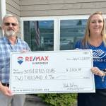 Pictured are Mark DeRousie of RE/MAX, and Janet Gray of the Boys & Girls Clubs.