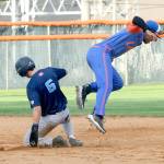 KEITH THORPE/PENINSULA DAILY NEWS Lefties second baseman Roberto Nuñez III is pushed off-balance into the air by charging Edmondton baserunner Brett Ott after Ott was forced out at second during the fourth inning on Wednesday at Port Angeles Civic Field.
