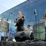 The Sweater Weather String Band, from left, Rico Vinh, Will Jevne, Adam Amr and Joey Gish, perform at Pebble Beach Park behind the Field Hall Arts & Events Hall during Saturdays grand opening celebration for the venue. (Keith Thorpe/Peninsula Daily News)