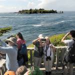 Visitors to Cape Flattery, the northwesternmost point in the contiguous United States, take scenic photos and selfies from the viewing platform on Tuesday as Tatoosh Island lies in the distance. The popular tourist attraction is part of an area administered by the Makah Tribe in Neah Bay. (Keith Thorpe/Peninsula Daily News)