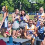 Port Angeles senior cheerleaders Jordyn Erdmann and Julia McDonald, center, tried out and made the Universal Cheerleaders Association All-American team while competing with the Riders cheer team at camp at University of Puget Sound. The All-American team performs at parades in Hawaii, Disneyland and London.