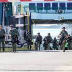 A multi-agency police force walks up the ramp after conducting a high-risk, low-frequency training exercise on board the M/V Kennewick on Wednesday. High risk refers to the level of danger to people and property, i.e., a hostage situation, and low frequency refers to the chance of it actually happening, but the agencies want to be prepared by training. The force was made up with personnel from the Port Townsend, Port Angeles and Sequim police departments and both the Clallam and Jefferson county sheriffs departments as well as from customs enforcement. The 8 a.m. and 9:30 a.m. ferries from Port Townsend were cancelled due to low tides, so travel was not impacted during the exercise. (Steve Mullensky/for Peninsula Daily News)