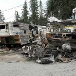 The charred remains of a pair of mobile homes sit on Saturday at the Emerald Mobile Home & RV Park in Port Angeles. (Keith Thorpe/Peninsula Daily News)