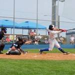 Port Angeles' Julio Vasquez hits a fly ball in the second inning Sunday against the Bellingham Bells at Civic Field in Port Angeles. (Pierre LaBossiere/Peninsula Daily News)