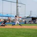 Port Angeles Julio Vasquez hits a fly ball in the second inning Sunday against the Bellingham Bells at Civic Field in Port Angeles. (Pierre LaBossiere/Peninsula Daily News)