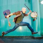 Tony Furtado clowns around with instruments.
