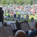 Photo by Richard Greenway, Sequim City Band/ A summer crowd settles in as Sequim City Band members and director Tyler Benedict prepare to play during the opening announcement of the Fourth of July concert.