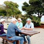 Carol and Greg Shinsky of Port Angeles take an afternoon break on a picnic table at the Port Angeles City Pier with visiting friends. Gay and Russ James, right, are visiting from Orland, Calif., where the temperature has been over 100 degrees. They rested at the pier after visiting Hurricane Ridge and the Dungeness Spit. The couples have known each other for years from when they both lived in Arizona. (Dave Logan/for Peninsula Daily News)