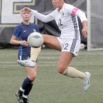 KEITH THORPE/PENINSULA DAILY NEWS Peninsulas Keilee Silva steps high for the ball as Bellevues Daisy Morris look on during Wednesdays match in Port Angeles.