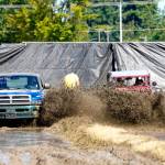 Richard Bauden of Port Angeles, left, in a 2000 Dodge, gets edged out for second place by Poulsbos Carl Jantz, driving a 1942 Willys Jeep during the Jefferson County Fair in Port Townsend on Sunday. Jantz won the 2014 Alaska Offroad Warriors reality competition off-road race with this vehicle, which covered 1,100 miles from south to north to the Arctic Ocean. (Steve Mullensky/for Peninsula Daily News)