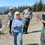 Sen. Patty Murray, center, listens to Olympic National Park Superintendent Sula Jacobs, right, explain the ongoing investigation into the cause of the fire that destroyed the Hurricane Ridge Day Lodge on May 7 and the parks efforts to maintain visitor access this summer and possibly into the winter. (Paula Hunt/Peninsula Daily News)