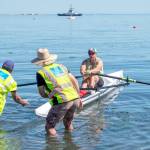 Steven Rice from Oregons Lake Oswego Community Rowing, winner of the high handicap solo division, is aided by boat Handlers are Dave Mittmann (left) and Craig Fulton, both of Port Angeles during the Olympic Peninsula Rowing Associations Inaugural OPRA Coastal Beach Regatta at Hollywood Beach on Sunday. Coastal beach rowing is a new rowing event which includes running beach starts, slalom rowing on a short 250 meter course, followed by a 250 meter sprint back to shore for a final run across the beach. Sundays events included both solo and double rowing heats, with rowers broken in High Handicap and Low Handicap categories.