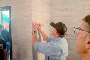 Eric Coufal signs a letter urging Olympic National Park officials to ensure access to Hurricane Ridge this winter. Locals have been concerned about winter access after the ridges day lodge burned down in May. A local coalition held a meeting at the Red Lion Hotel in Port Angeles on Wednesday to discuss the situation. (Peter Segall/Peninsula Daily News)