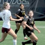 Peninsulas Tara Bohenko, right, battles with North Idahos Marina Smith, left, for a loose ball as Bohenkos teammate, Rylie Echavaria, looks on during Saturdays match in Port Angeles. (Keith Thorpe/Peninsula Daily News)