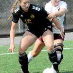 Peninsulas Shawna Larson, left, keeps the ball inbounds in the corner as North Idahos Ansley Kerley defends on Saturday in Port Angeles. (Keith Thorpe/Peninsula Daily News)