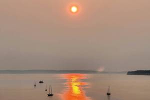 Smoke from wildfires in eastern Washington and Canada contribute to the red, smokey sunrise on Sunday over Port Townsend. (Steve Mullensky/for Peninsula Daily News)