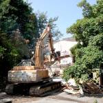 Demolition began Monday morning on the derelict two-story brick building at 204 E. Front St. in Port Angeles. A 300-foot section of Front Street will be shut down while the work is being done, and that could stretch into next week. The developer has said he has plans for an apartment building on the site. (Dave Logan/for Peninsula Daily News)