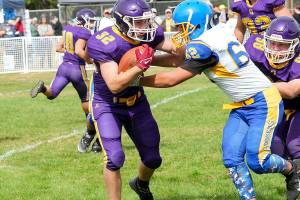 Steve Mullensky/for Peninsula Daily News
Quilcene’s Mason Iverson, left, fights for yardage during a Sept. 2022 game against Crescent. Iverson led the Rangers in rushing yards last season and returns at fullback for Quilcene.