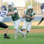 Port Angeles Kason Albaugh, center, gets a block from teammate Landyn Jones as Anacortes defenders Brock Beaner, left, and Braden Thomas close in during the first quarter on Friday in Port Angeles. (Keith Thorpe/Peninsula Daily News)
