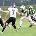 Keith Thorpe/Peninsula Daily News
Port Angeles' Parker Nickerson looks for a way around the defense of Anacortes' Hayden John, left, Rylin Lang and Brock Beaner as teammate Kason Albaugh looks on from behind on Friday at Port Angeles Civic Field.