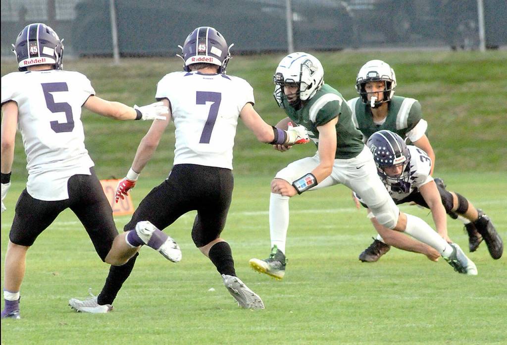 Keith Thorpe/Peninsula Daily News
Port Angeles' Parker Nickerson looks for a way around the defense of Anacortes' Hayden John, left, Rylin Lang and Brock Beaner as teammate Kason Albaugh looks on from behind on Friday at Port Angeles Civic Field.