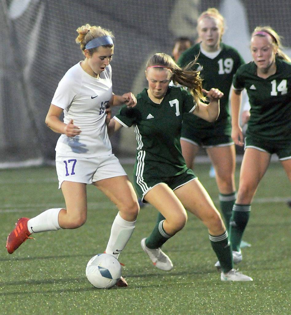 KEITH THORPE/PENINSULA DAILY NEWS Sequims Kaia Lestage, left, fights for control with Port Angeles Isabelle Felton, as Feltons teammates, Kedryn DeScala and Anna Petty, right, look on during Thursdays match at Wally Sigmar Field in Port Angeles.